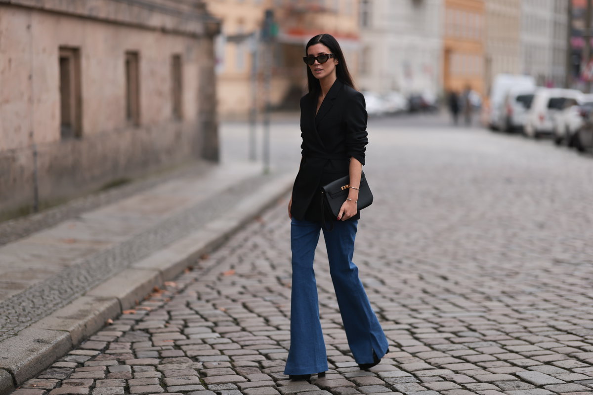 Frau in Jeans-Schlaghose und Blazer