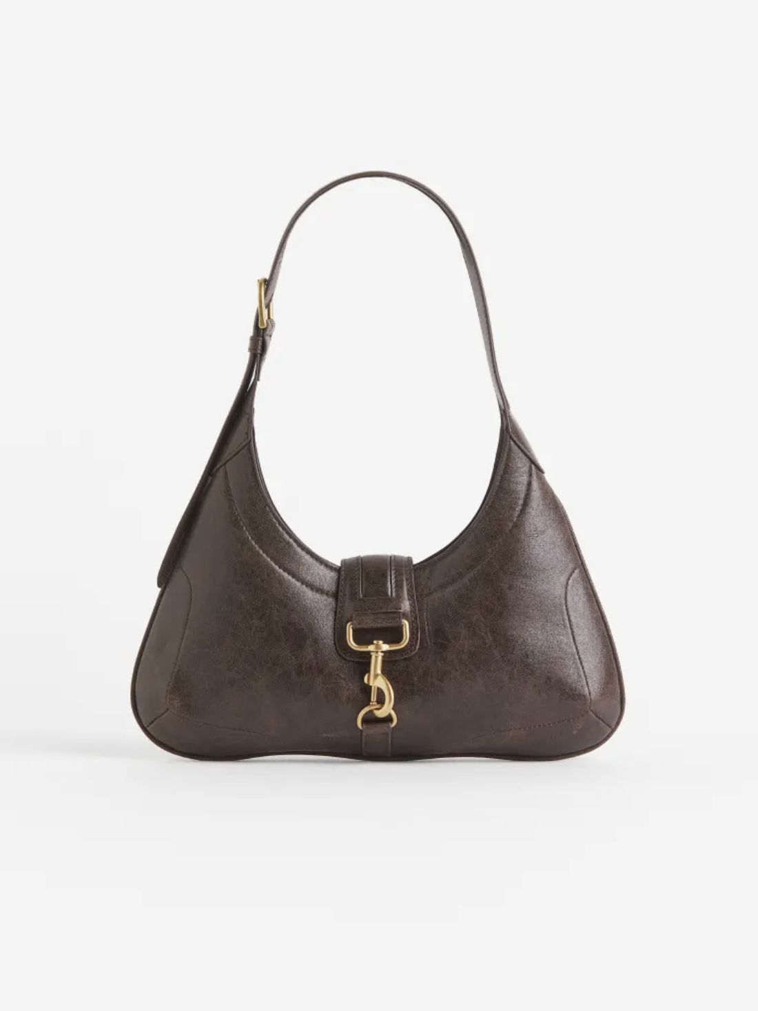 Einzigartige Form, goldene Details und braune Leder-Optik – die Handtasche von H&M für ca. 31 Euro sieht definitiv teurer aus, als sie ist.