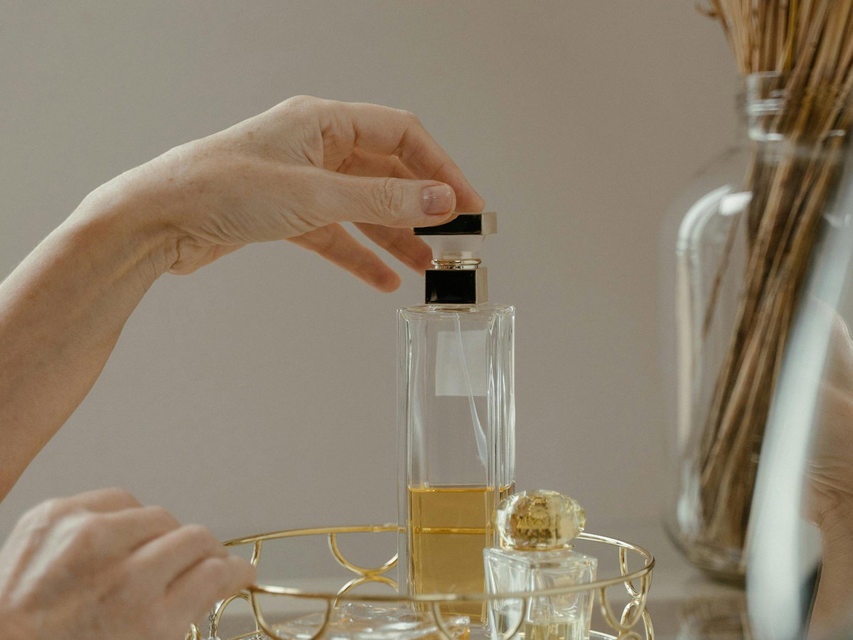 Frau greift zu einem Parfum
