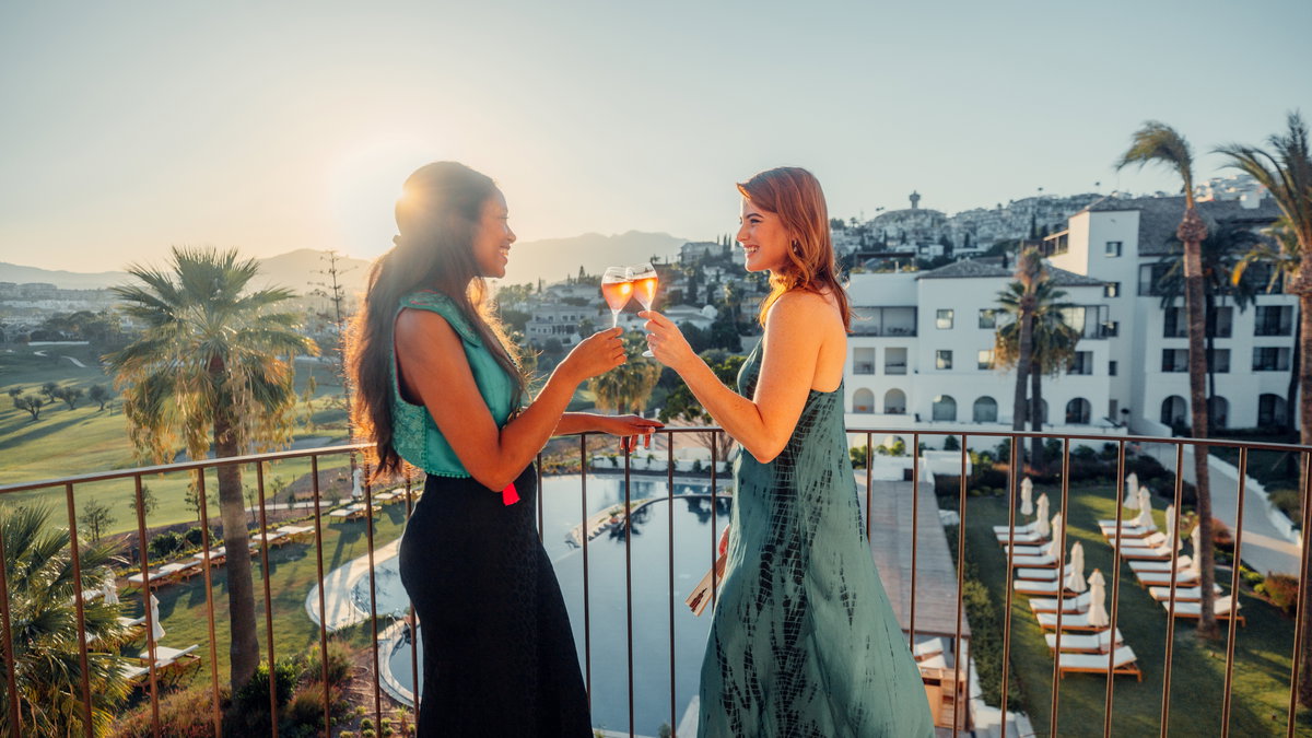 women-toasting-balcony
