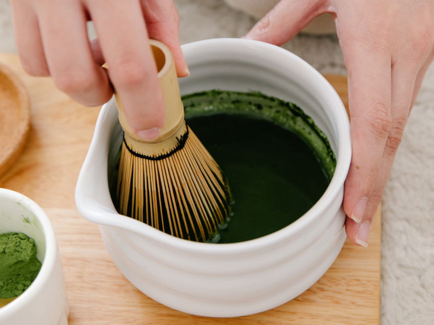 Frau bereitet einen Matcha vor