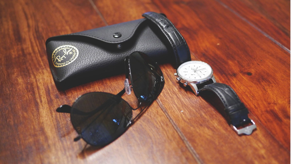 Eine Sonnenbrille und eine Uhr in Schwarz
